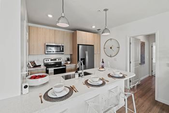 An open kitchen with a large counter top and a sink